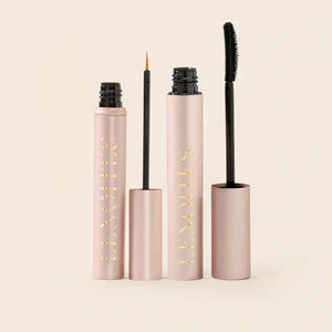 Lash Duo by Lenoites featuring a rosegold Eyelash Growth Serum with a fine applicator and a black PowerLash Growth Serum Mascara with a two sided brush, displayed on a soft beige background.