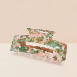 Eco-friendly Hair Claw Medium in Blossom by Lenoites, featuring the brand logo in gold, displayed against a soft beige background.