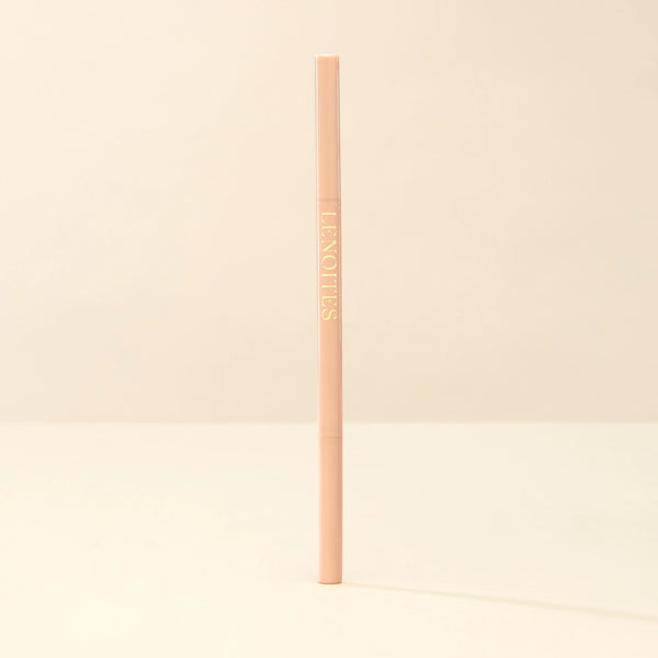 Brow Micro Sculpting Pencil by Lenoites, featuring a sleek, slim pencil in a soft pink shade with gold branding, displayed against a soft beige background.