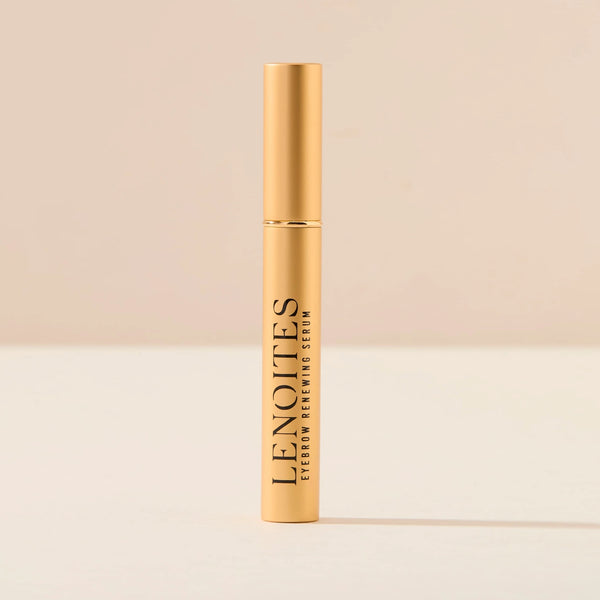 Eyebrow Growth Serum by Lenoites, featuring a sleek gold tube with black text, displayed against a soft beige background.