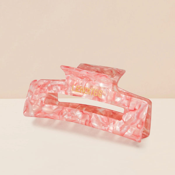 Eco-friendly Hair Claw Medium in Candy Pink by Lenoites, featuring the brand logo in gold, displayed against a soft beige background.