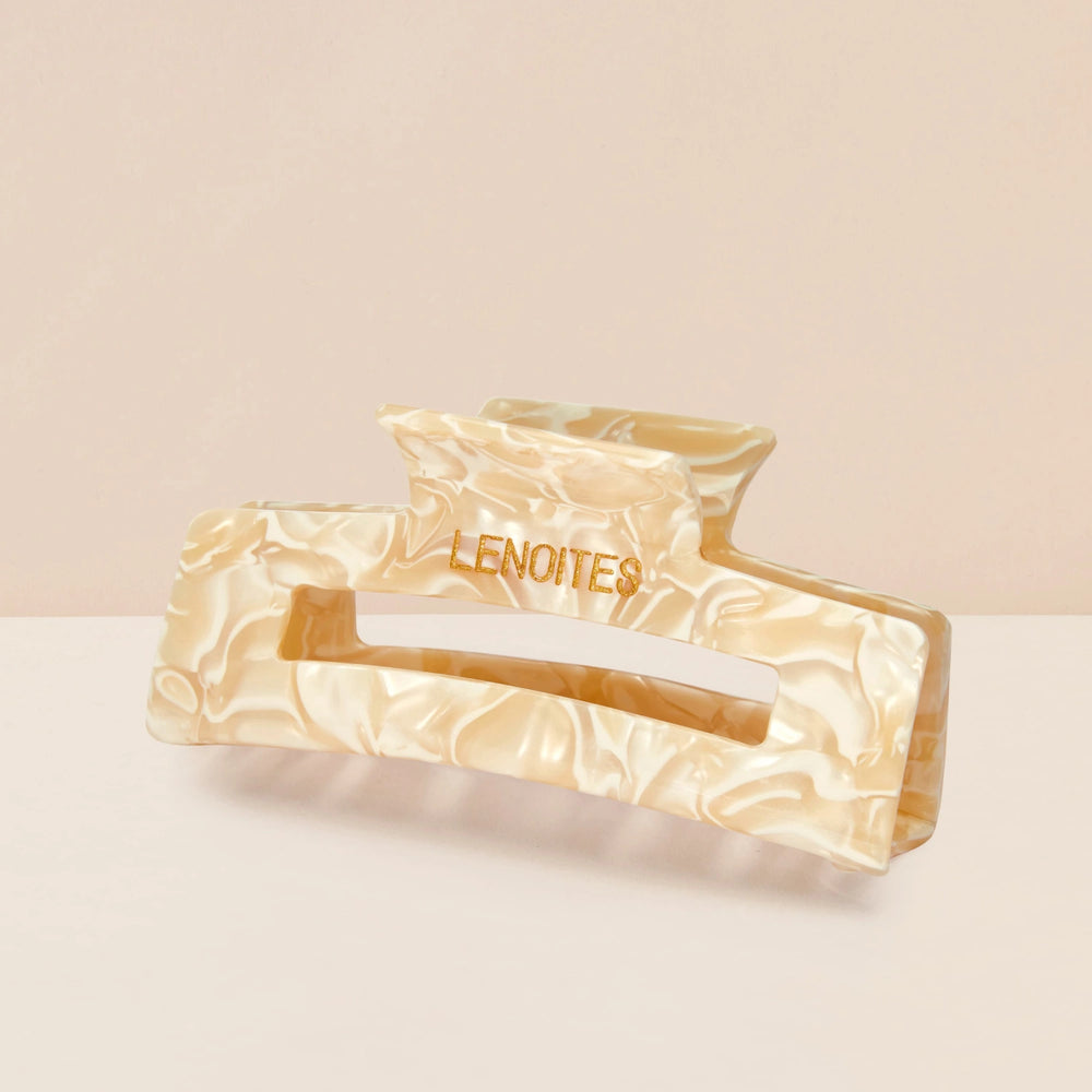 Eco-friendly Hair Claw Medium in Champagne Pearl by Lenoites, featuring the brand logo in gold, displayed against a soft beige background.