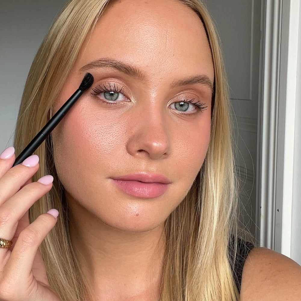 Brush Me Blending Angled Brush No. 103 by Lenoites, featuring a sleek black handle and a soft angled brush head, displayed against a soft beige background.