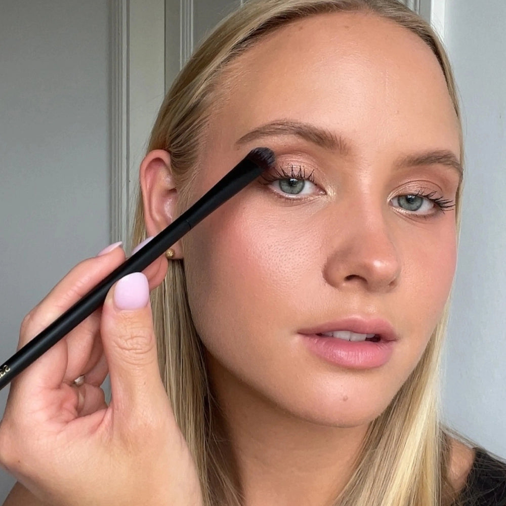 Brush Me Blending Multi Eye Brush No. 134 by Lenoites, featuring a sleek black handle with a soft, rounded brush head, displayed against a soft beige background.