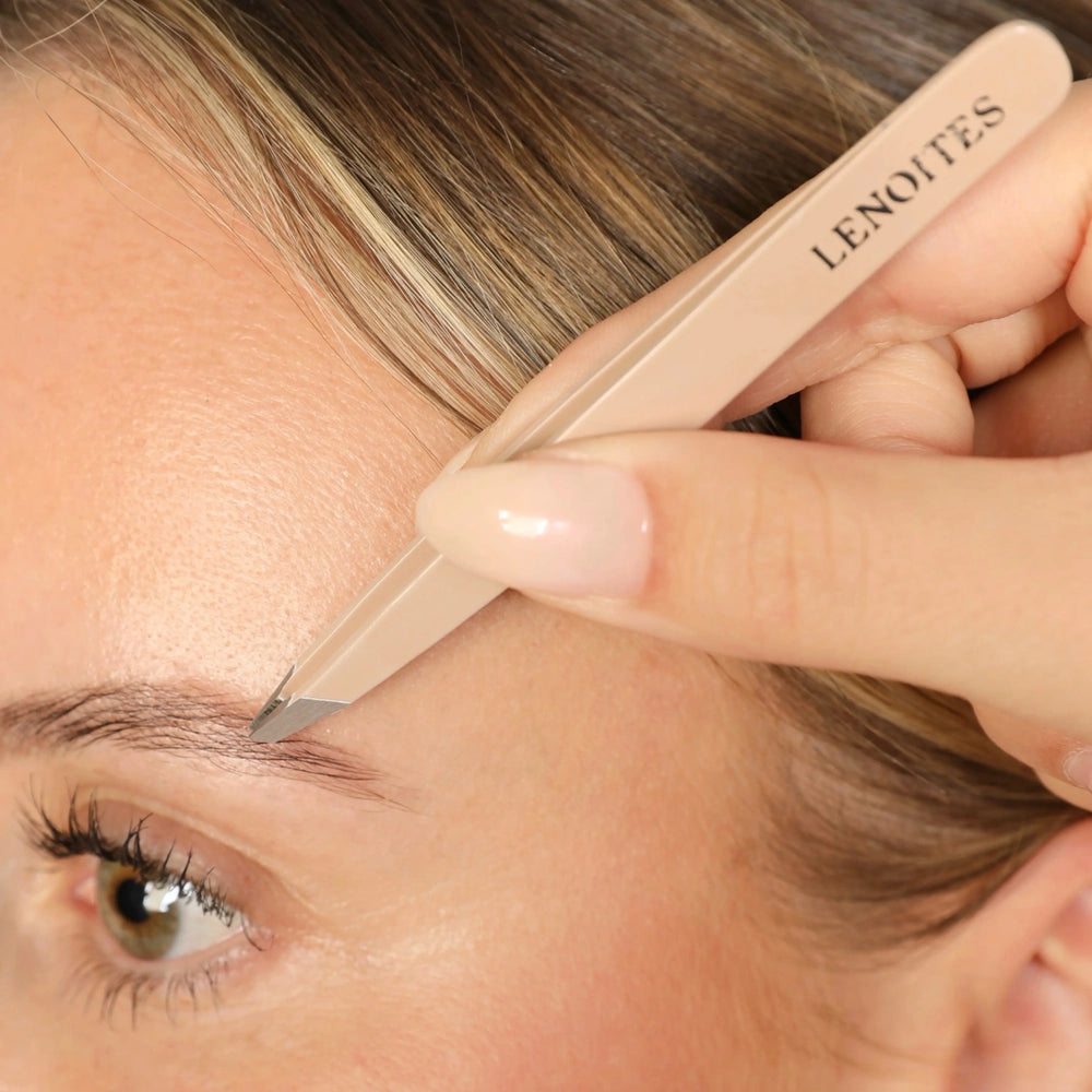 Premium Slant Tweezer by Lenoites, featuring a sleek, angled pink handle with a black protective case, displayed against a soft beige background.