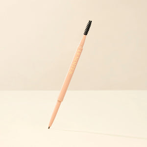 Brow Micro Sculpting Pencil in Medium Brown by Lenoites, featuring a dual-ended pencil with a spoolie brush on one end and a fine pencil tip on the other, displayed against a soft beige background.
