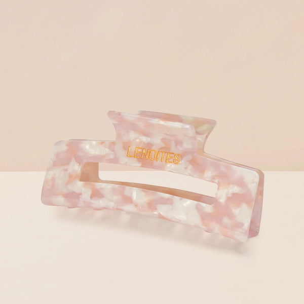 Eco-friendly Hair Claw Medium in Pearly Pink by Lenoites, featuring the brand logo in gold, displayed against a soft beige background.