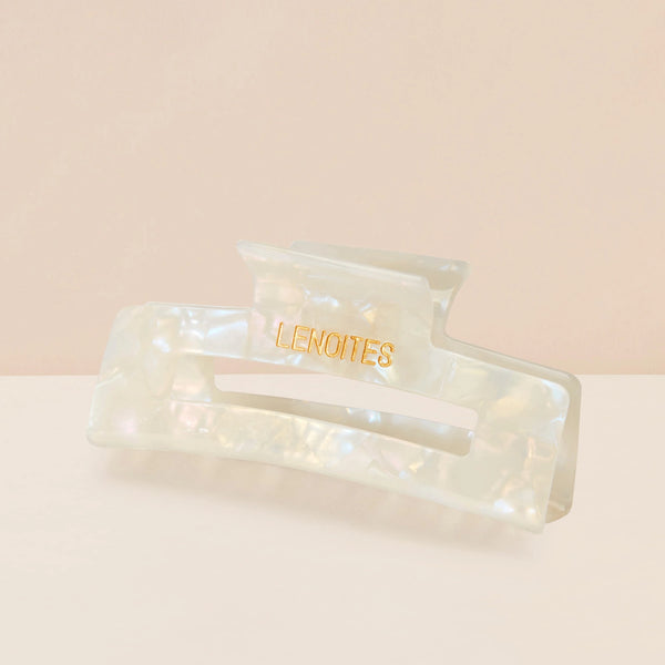 Eco-friendly Hair Claw Medium in Pearly White by Lenoites, featuring the brand logo in gold, displayed against a soft beige background.