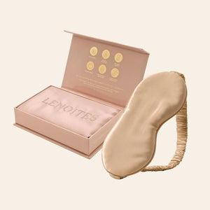Pillowcase and Sleep Mask in Mulberry Silk by Lenoites featuring a beige silk sleep mask and a pink mulberry silk pillowcase presented in an open blush pink box against a soft light background.