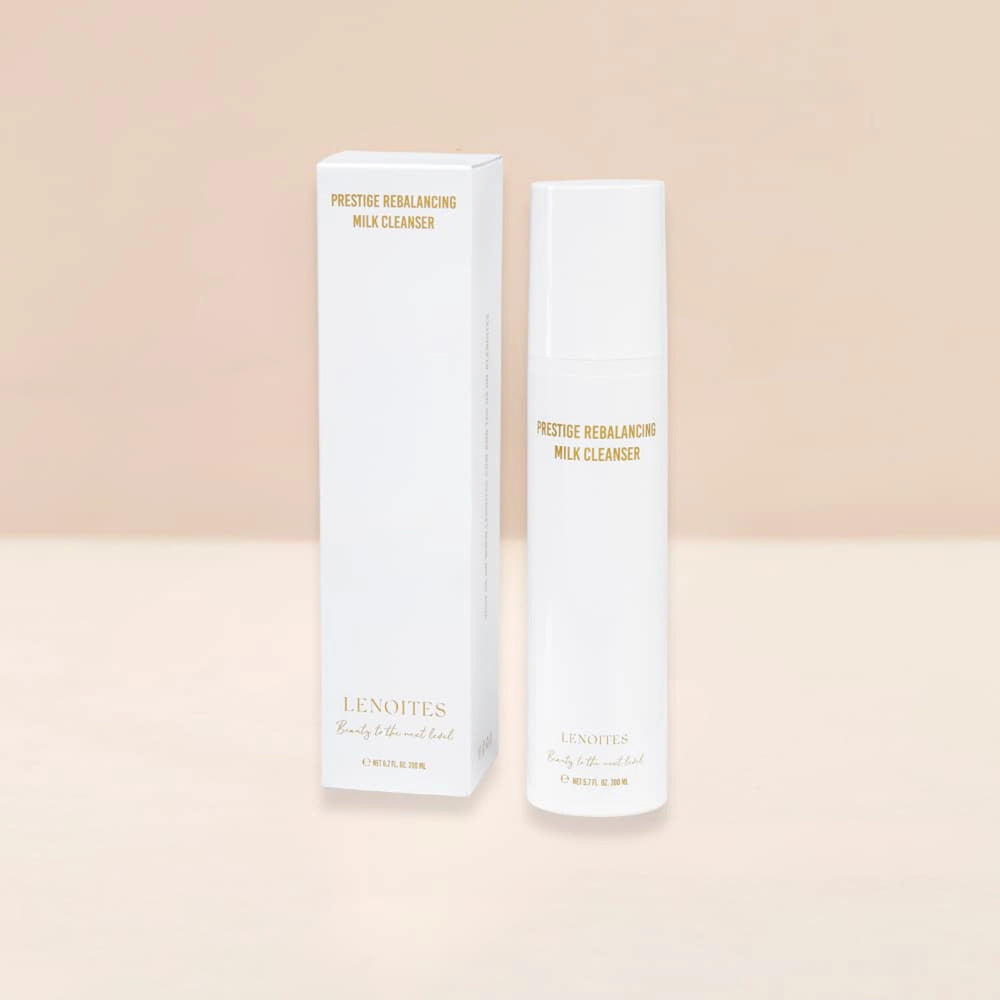 Prestige Rebalancing Milk Cleaner by Lenoites, featuring a sleek white bottle with gold text, placed next to its packaging, displayed against a soft beige background.